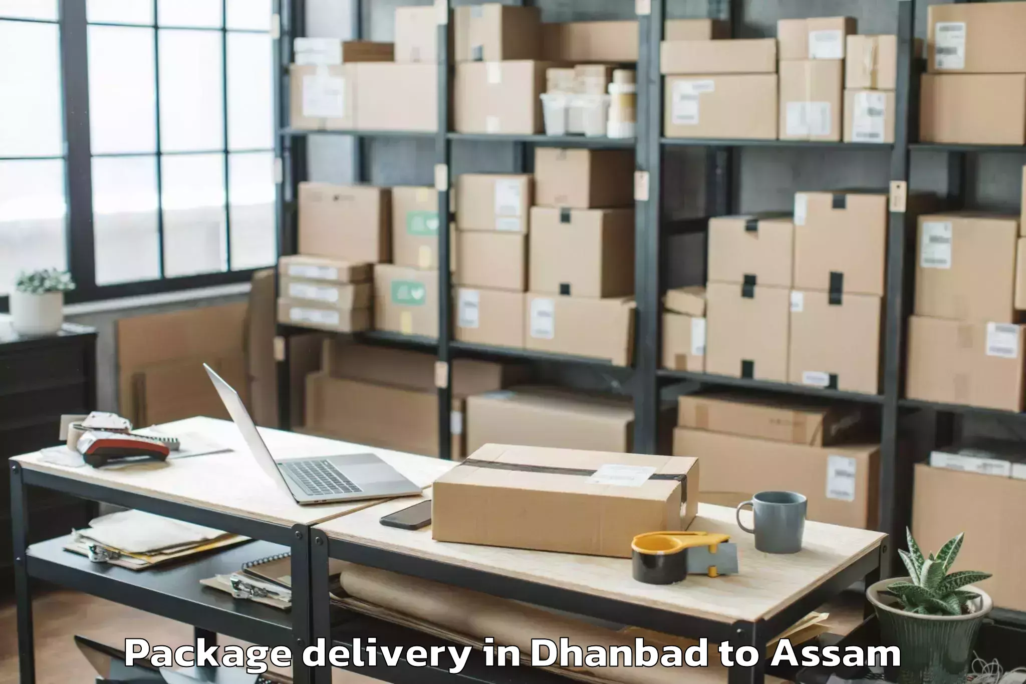 Dhanbad to Marigaon Package Delivery Booking